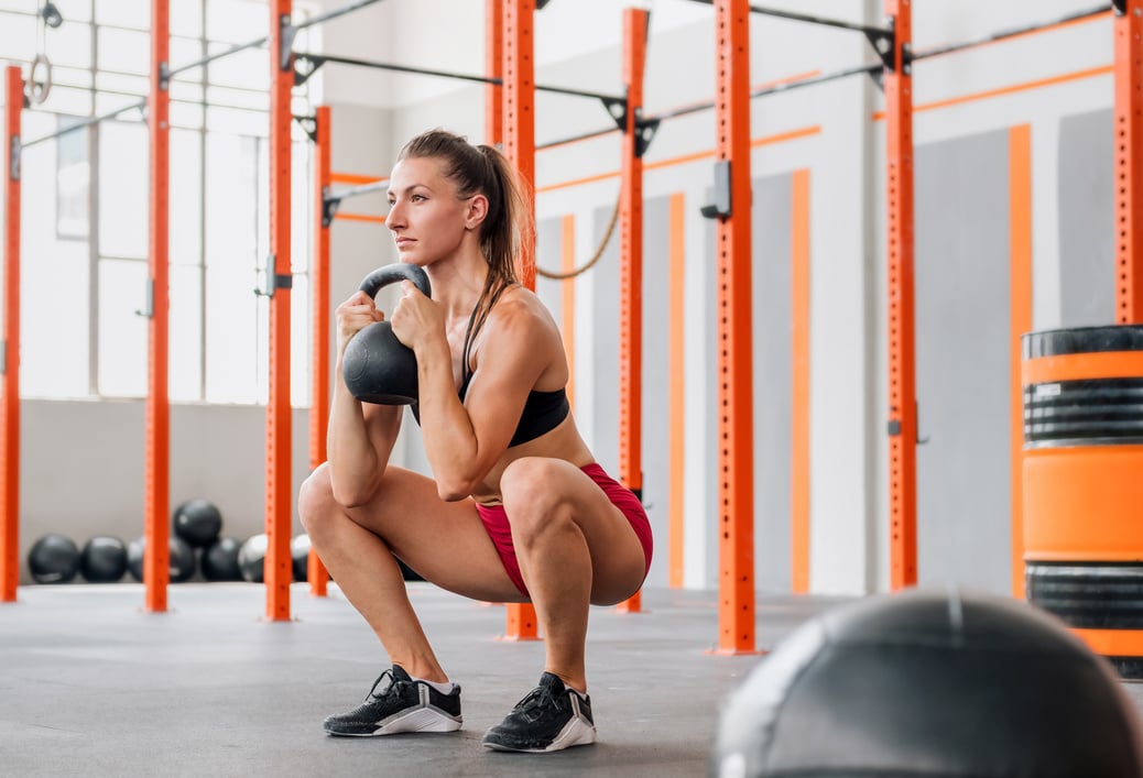 Sportswoman doing kettlebell goblet squat